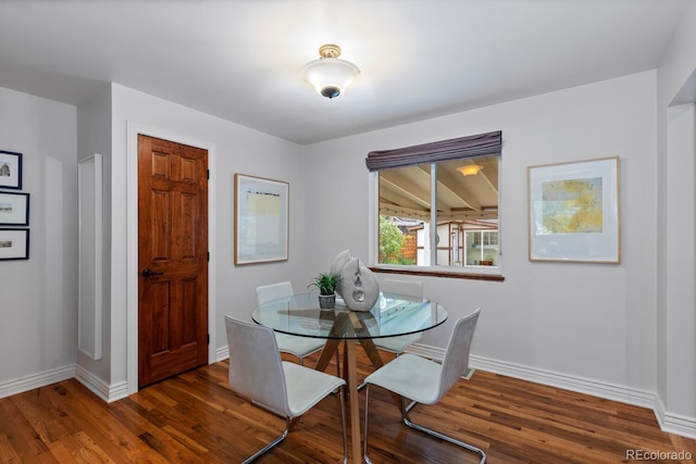 dining area featuring wood finished floors and baseboards
