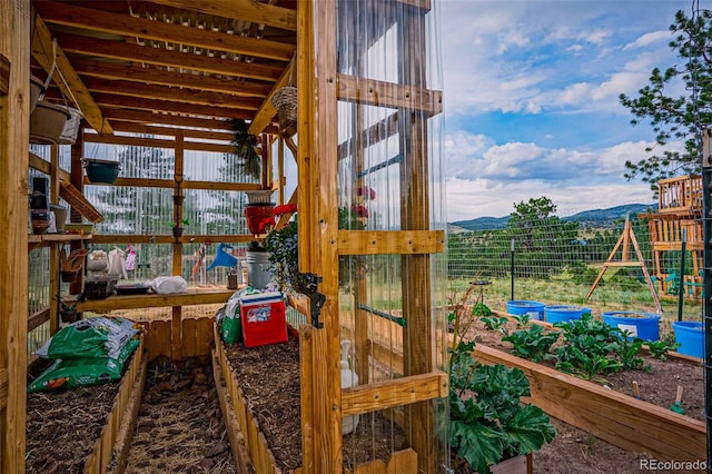 view of jungle gym featuring a mountain view