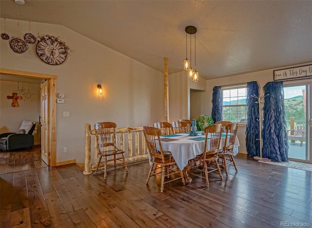 dining room with vaulted ceiling, a textured ceiling, and hardwood / wood-style floors