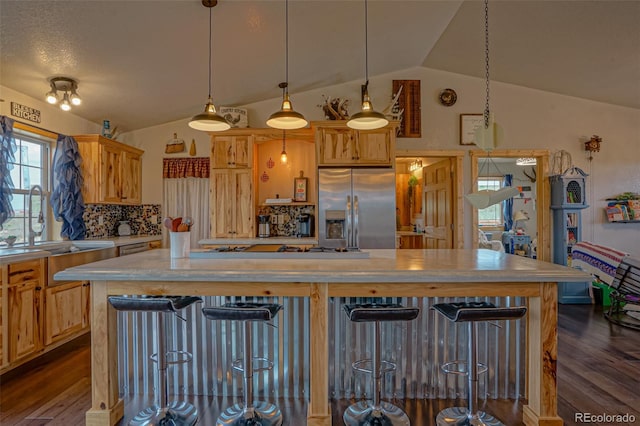 kitchen with appliances with stainless steel finishes, tasteful backsplash, vaulted ceiling, and dark wood-type flooring