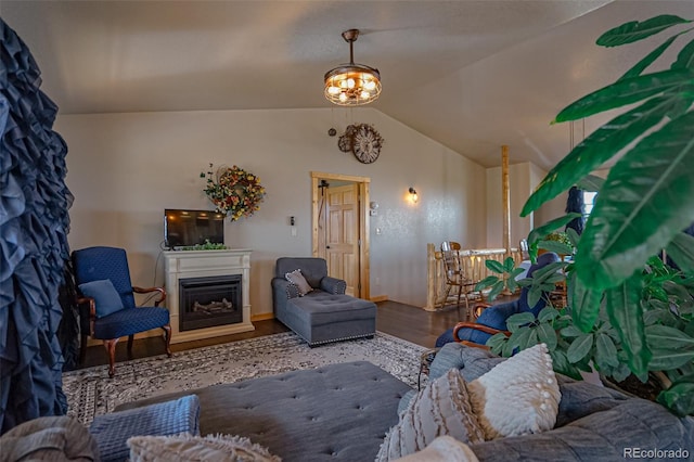 living room with a notable chandelier, vaulted ceiling, and hardwood / wood-style floors