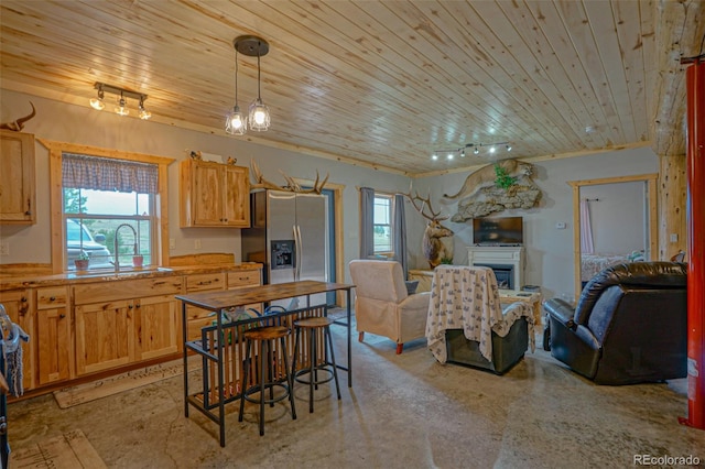 kitchen with sink, wooden ceiling, rail lighting, and a wealth of natural light