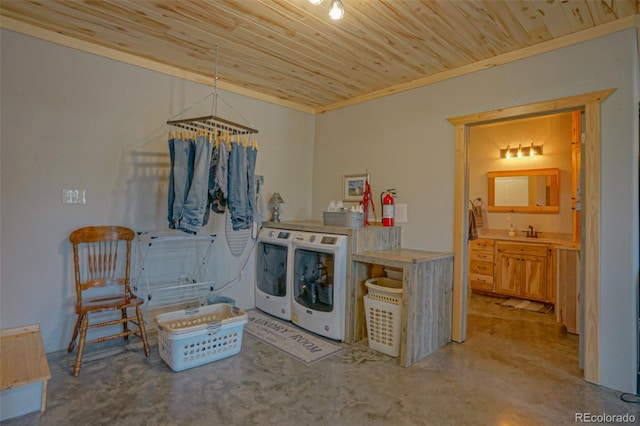 kitchen with separate washer and dryer, pendant lighting, sink, and wooden ceiling