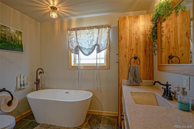 bathroom with vanity, toilet, and tile patterned floors