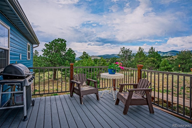 wooden terrace featuring a mountain view and area for grilling