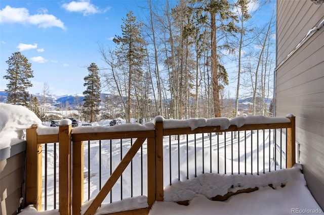 snow covered deck featuring a mountain view