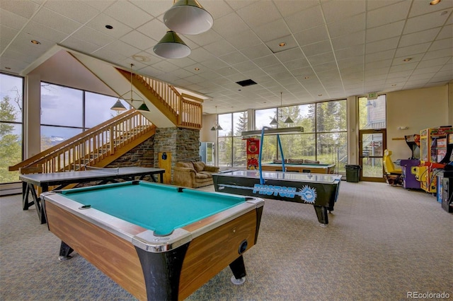 playroom featuring light colored carpet, a drop ceiling, billiards, and a wall of windows