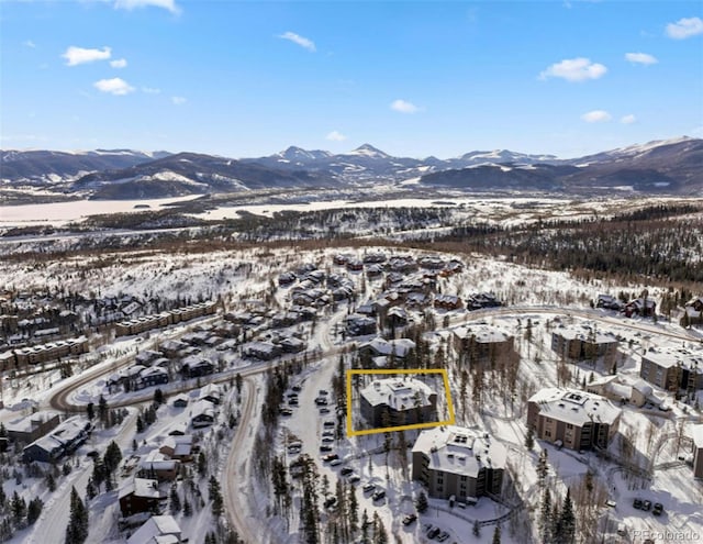 snowy aerial view with a mountain view