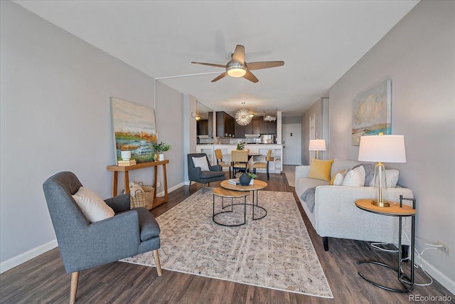 living room featuring ceiling fan, dark wood-style flooring, and baseboards