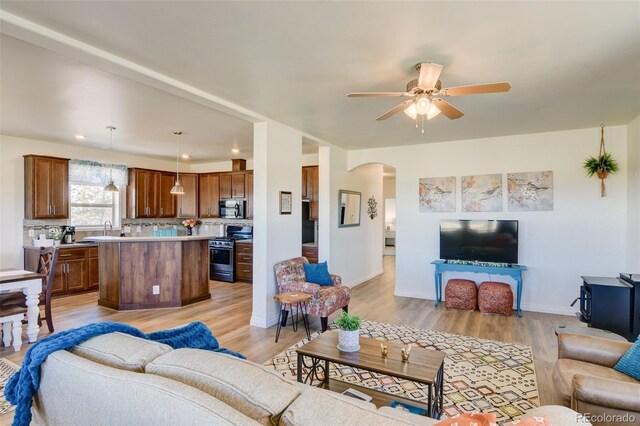 526 Wagon Wheel Rd, Hartsel, CO 80449 - living room with arched walkways, light wood finished floors, ceiling fan, baseboards, and recessed lighting