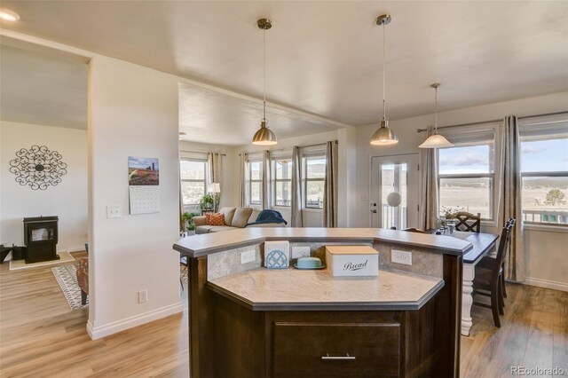526 Wagon Wheel Rd, Hartsel, CO 80449 - kitchen with open floor plan, dark brown cabinetry, light wood-type flooring, and baseboards