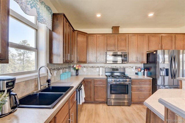526 Wagon Wheel Rd, Hartsel, CO 80449 - kitchen with appliances with stainless steel finishes, a sink, light countertops, backsplash, and brown cabinetry