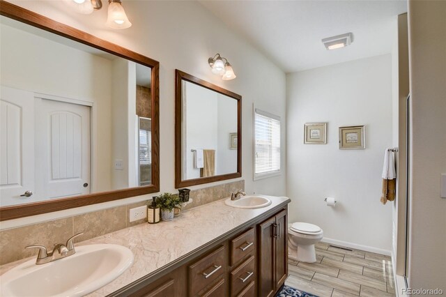 526 Wagon Wheel Rd, Hartsel, CO 80449 - bathroom with toilet, baseboards, wood finished floors, and double vanity