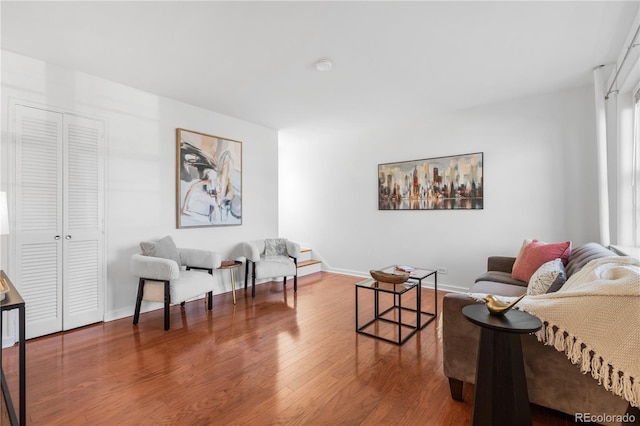 living area featuring baseboards and wood finished floors