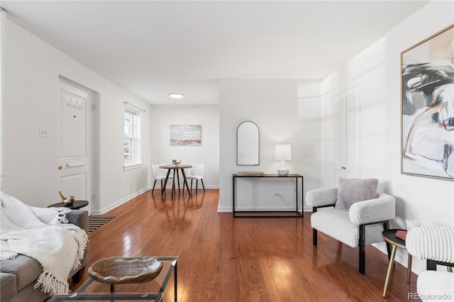 living area featuring baseboards and wood finished floors