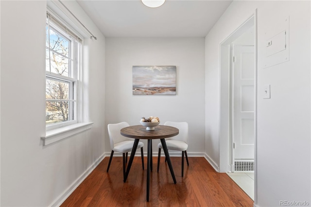 dining area with visible vents, wood finished floors, and baseboards