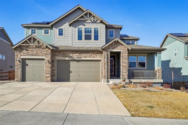 craftsman-style house featuring a porch, solar panels, driveway, and a garage