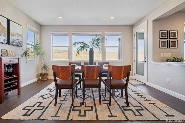 dining area with dark wood-style floors, recessed lighting, and baseboards