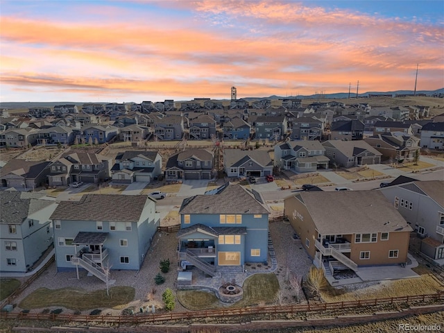 aerial view at dusk featuring a residential view