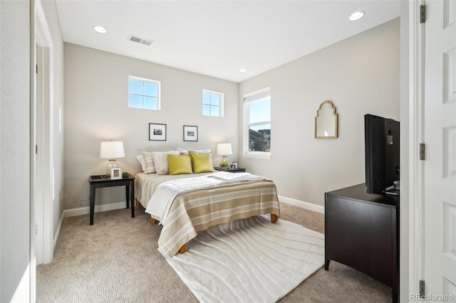 bedroom with light carpet, visible vents, recessed lighting, and baseboards