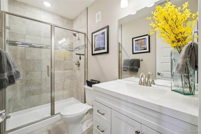 full bathroom with visible vents, toilet, a stall shower, and vanity