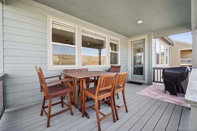 deck with area for grilling and outdoor dining space