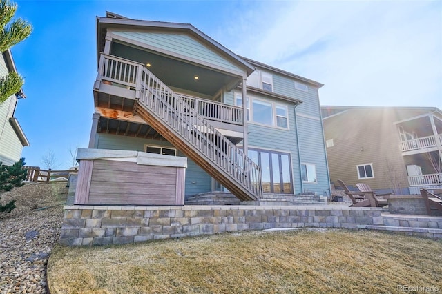 rear view of house with stairway and a patio