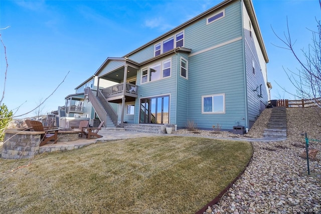 rear view of property featuring a lawn, a patio, a fire pit, central AC unit, and stairs