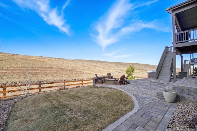 view of yard with stairway, a patio, a fire pit, and fence