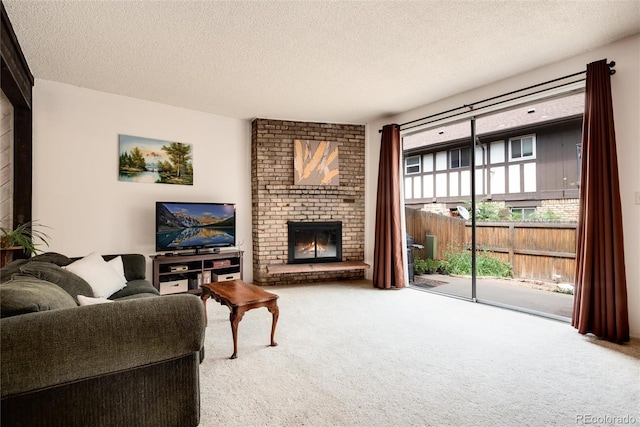 living room featuring a brick fireplace, a textured ceiling, and carpet flooring