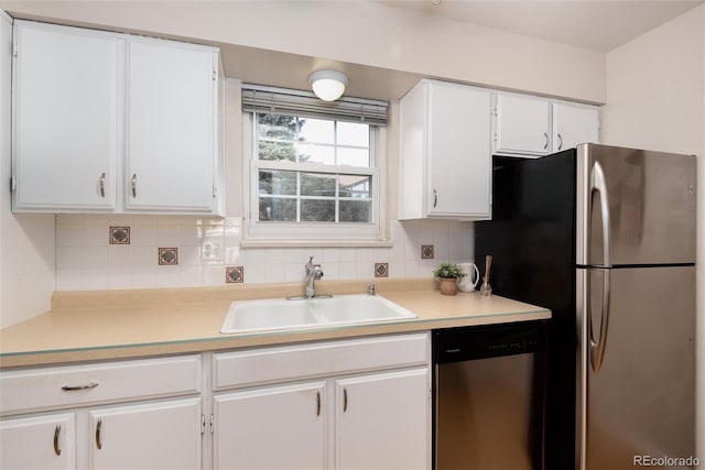 kitchen featuring white cabinetry, appliances with stainless steel finishes, sink, and decorative backsplash