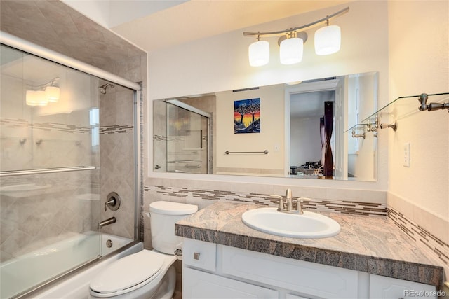 full bathroom with vanity, backsplash, enclosed tub / shower combo, and toilet