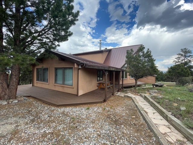 view of home's exterior featuring a wooden deck