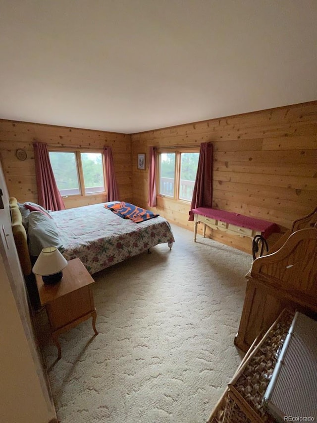 carpeted bedroom with wood walls