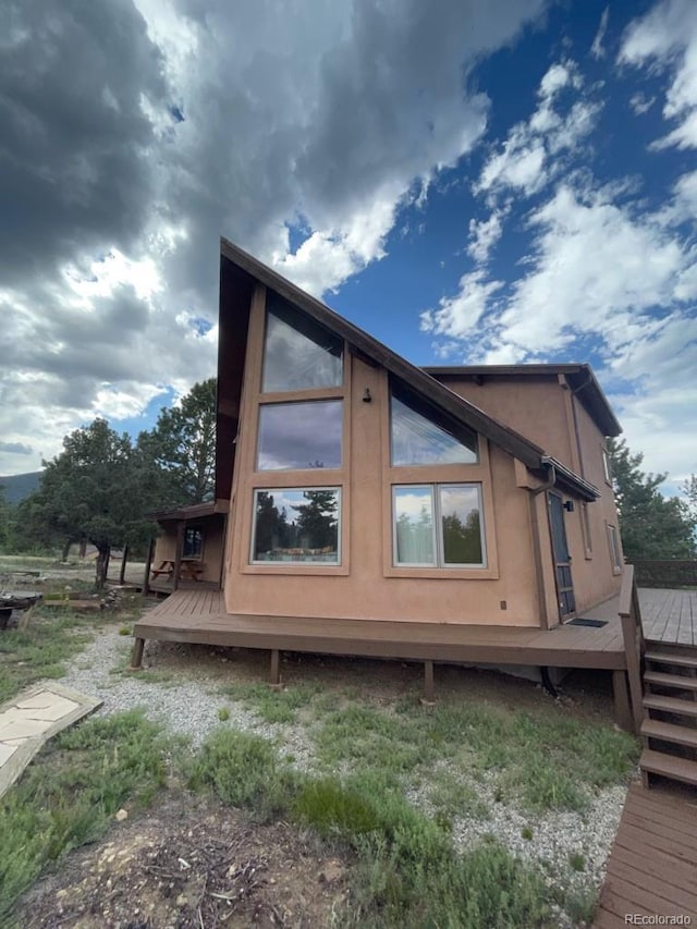 view of side of property featuring a deck