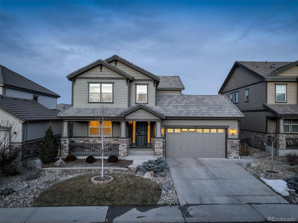 craftsman-style home featuring a garage and covered porch