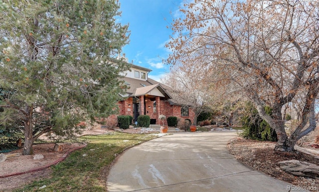 exterior space with brick siding and driveway