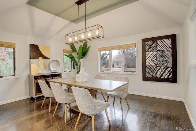 dining room with baseboards, dark wood finished floors, and a notable chandelier