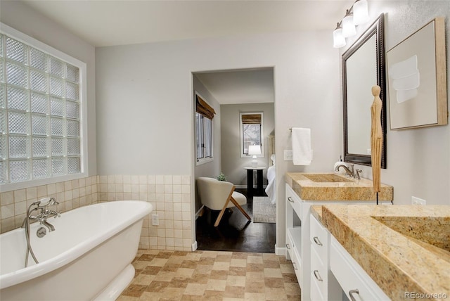 bathroom featuring a freestanding bath and vanity