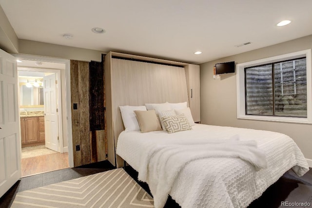 bedroom featuring recessed lighting, visible vents, and a sink