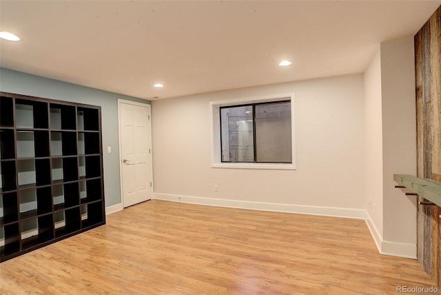 empty room featuring light wood-style floors, baseboards, and recessed lighting