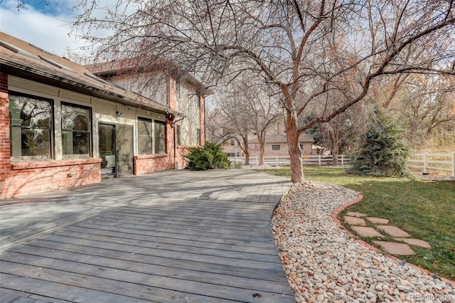 deck featuring a yard and fence