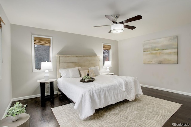 bedroom with baseboards, dark wood finished floors, and a ceiling fan