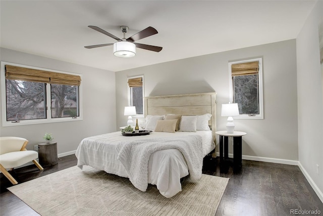 bedroom featuring dark wood-style floors, ceiling fan, and baseboards