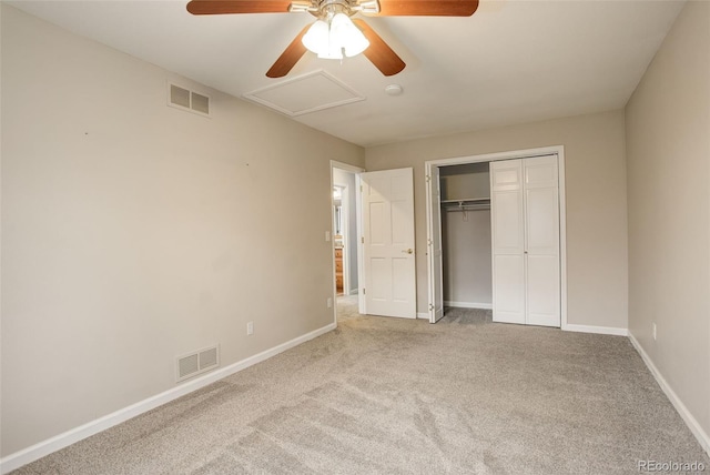 unfurnished bedroom with baseboards, carpet flooring, visible vents, and attic access