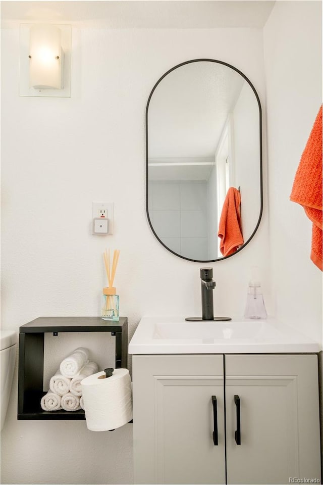 bathroom with vanity and toilet