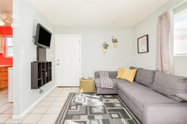 living area with light tile patterned floors and baseboards