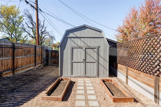 view of shed featuring a garden and a fenced backyard