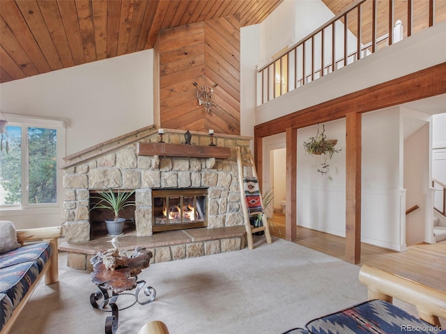 living room featuring a stone fireplace, high vaulted ceiling, and wood ceiling