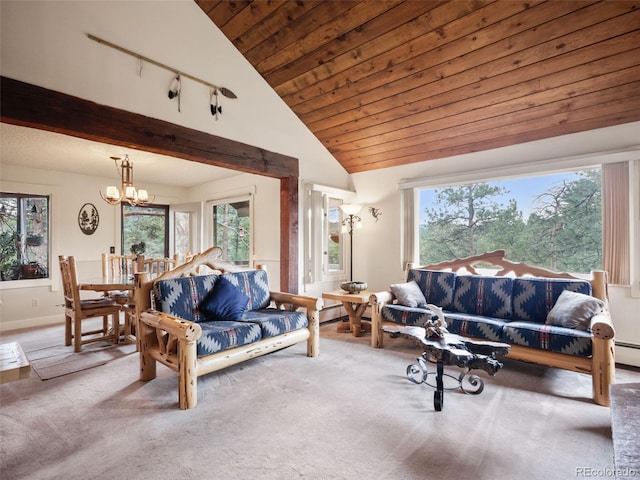 carpeted living area featuring baseboards, a notable chandelier, a healthy amount of sunlight, and vaulted ceiling